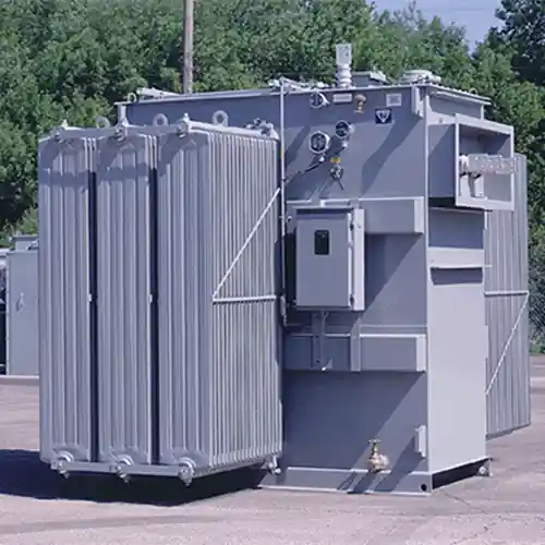 Oil‐filled three-phase step-up transformer at a power plant substation